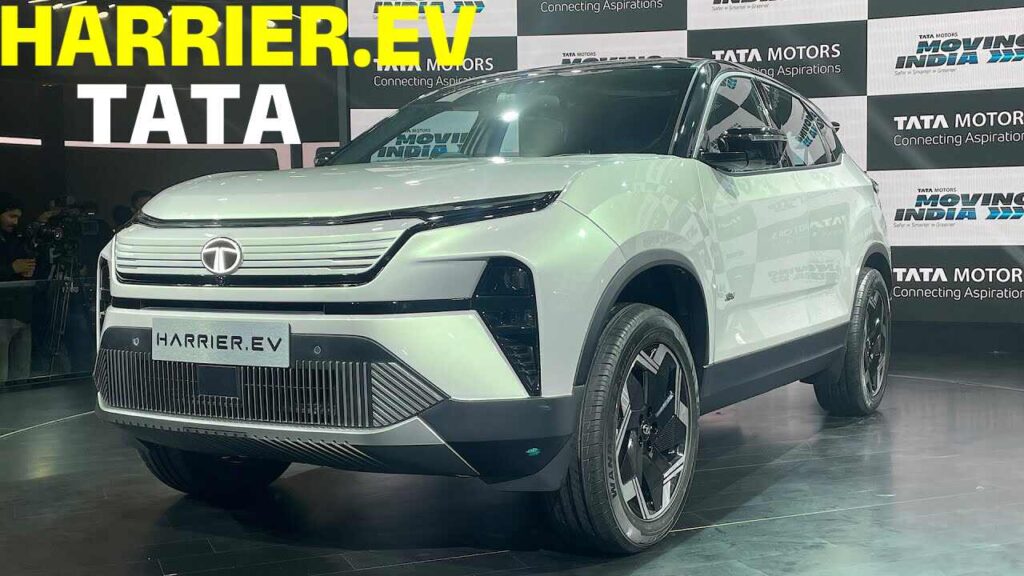 Side view of Tata Harrier EV showcasing its sleek design and closed-off grille on a scenic road.
