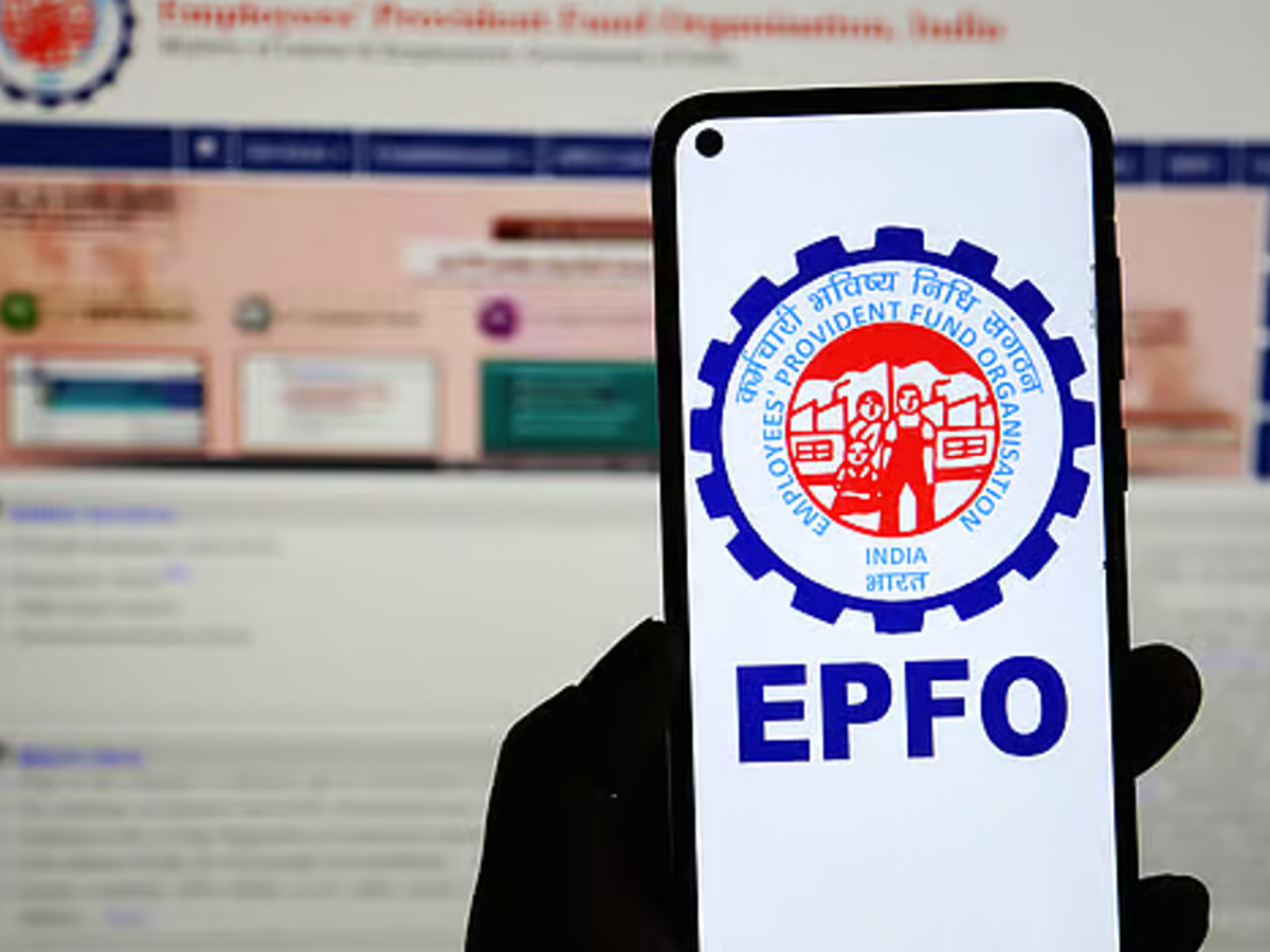 Person reviewing EPF passbook and ITR form on a desk with a calculator