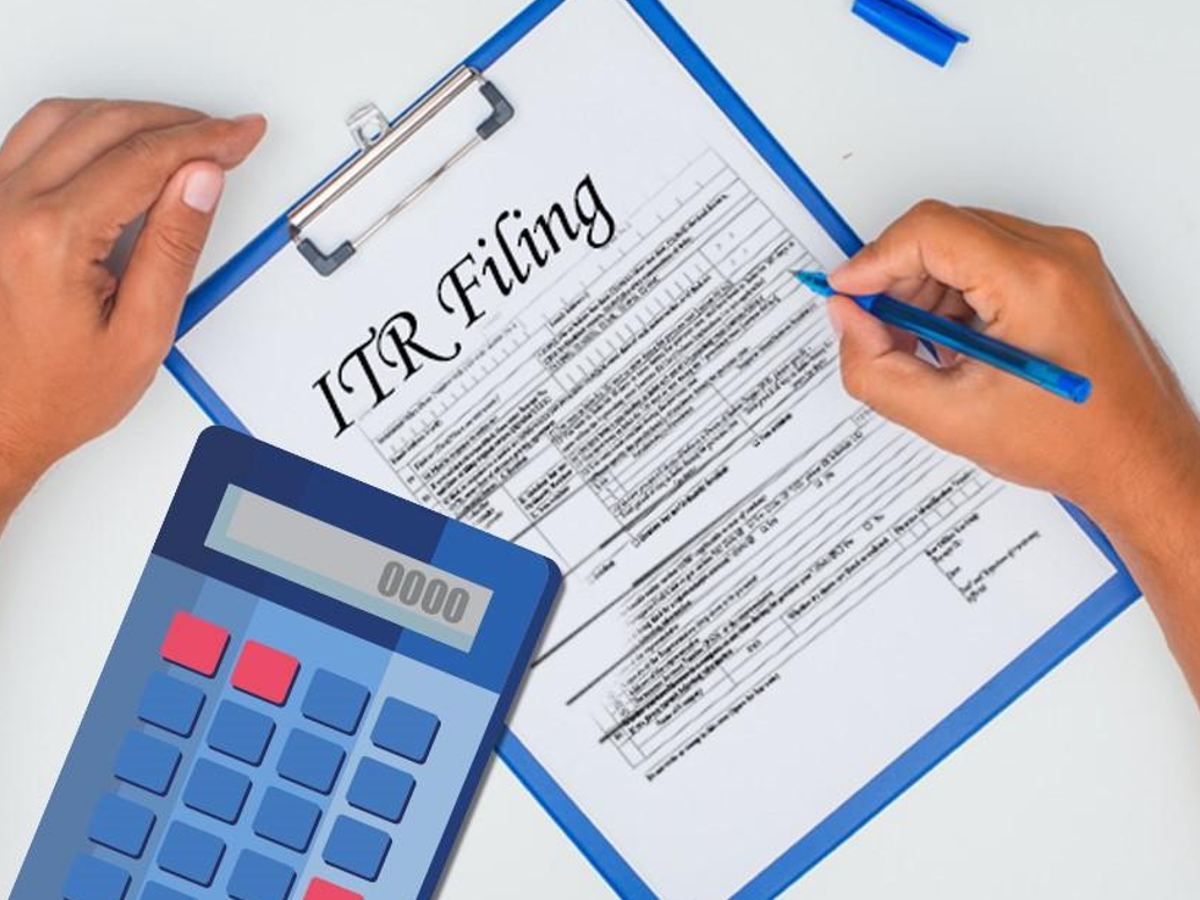 Person filing ITR online without Form 16 using documents and laptop for AY 2025-26