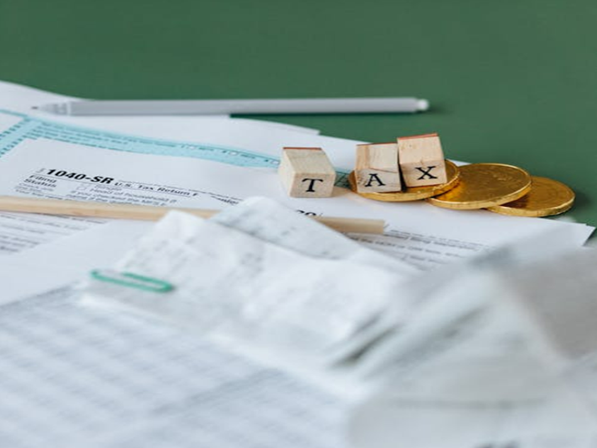 Senior citizen submitting Form 12BBA at a bank for income tax exemption