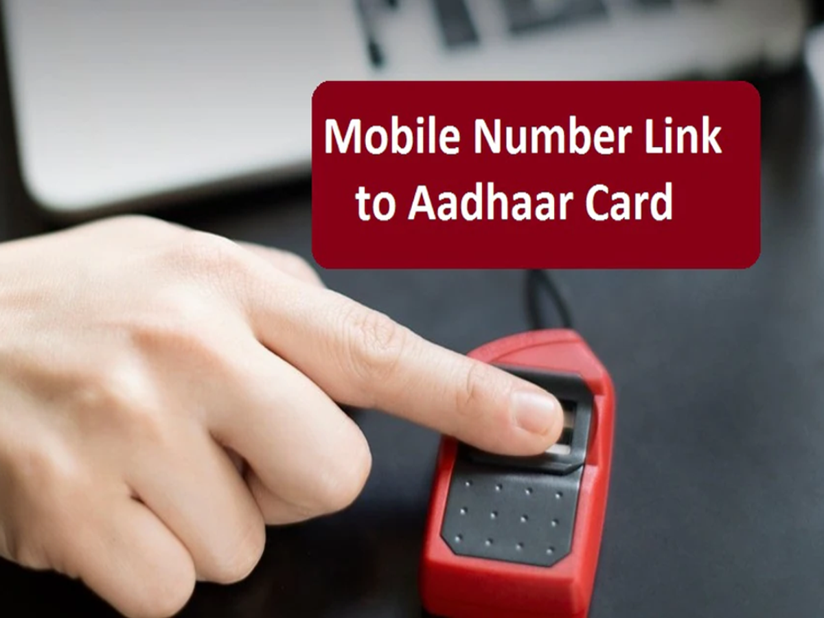 Close-up of a mobile phone displaying OTP for Aadhaar-mobile linking verification.