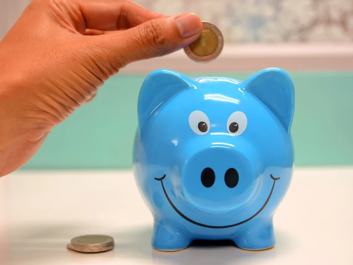 Illustration of a girl child with savings piggy bank for Sukanya Samriddhi Yojana