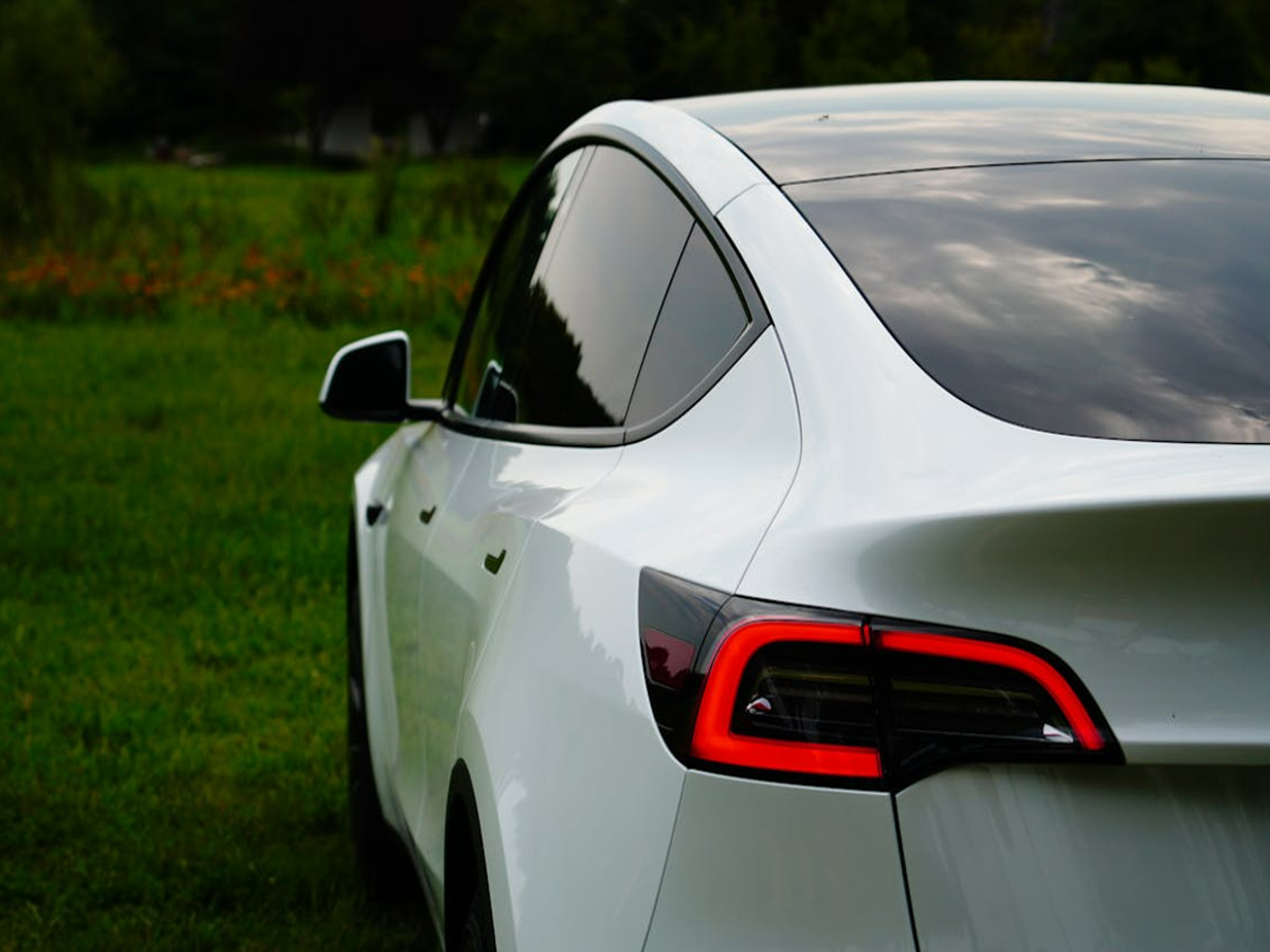 Tesla Model Y electric SUV on display at Mumbai’s BKC showroom, showcasing sleek design and advanced technology.