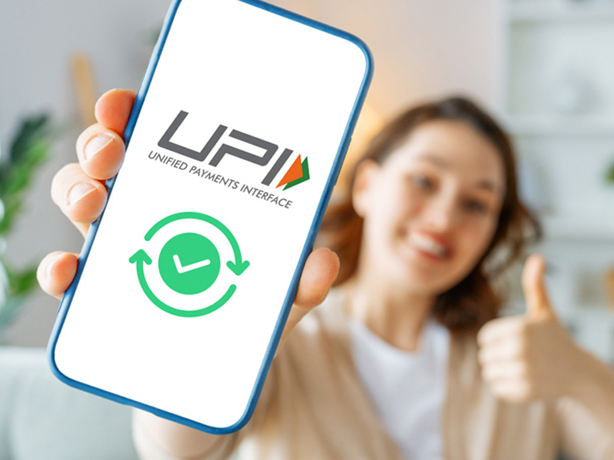 Illustration of a smartphone screen showing UPI app linked to gold and property loan accounts for withdrawals