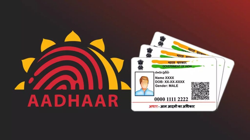 Aadhaar card with a mobile phone displaying UIDAI website for recovering lost Aadhaar number.