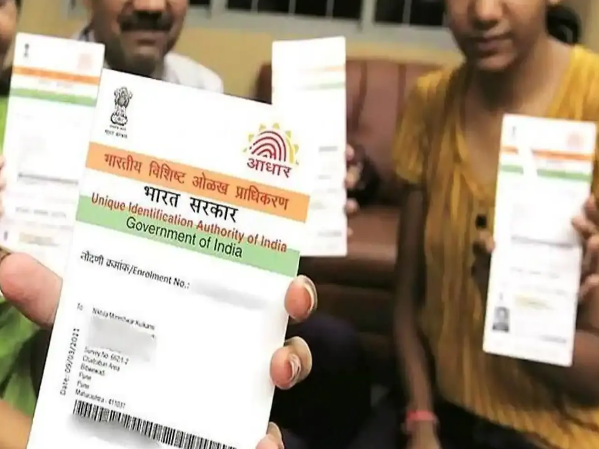 Person using a laptop to access UIDAI portal for retrieving Aadhaar number online.