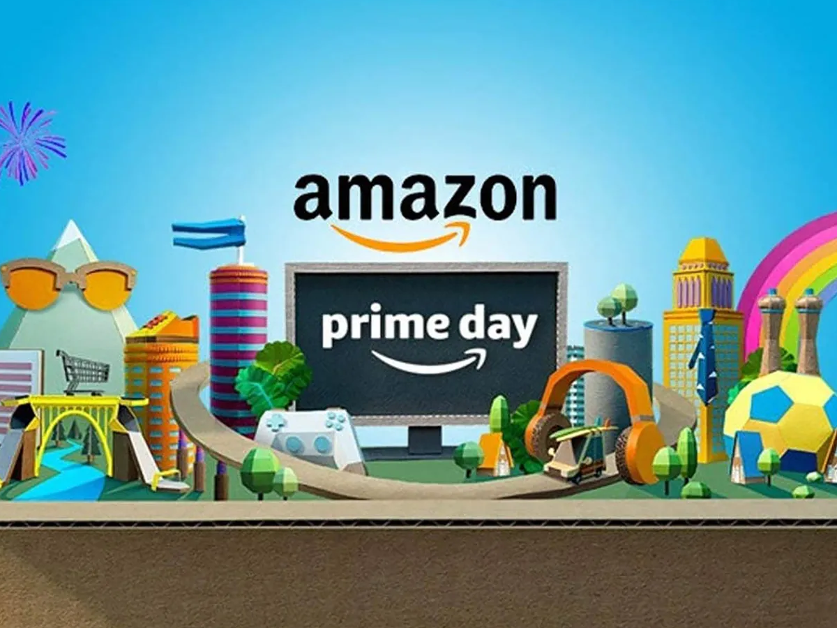 A person browsing Amazon Prime Day deals on a laptop with a colorful sale banner in the background.