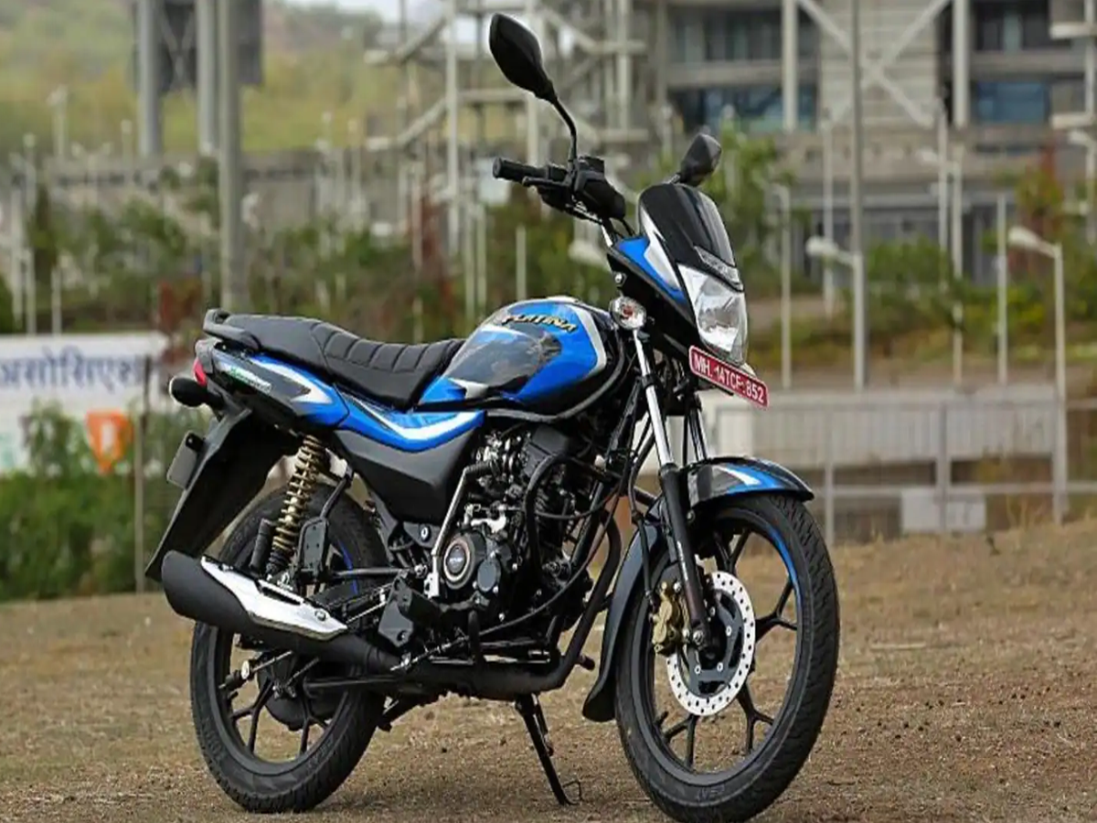 A Bajaj Platina 100 motorcycle parked on a city street, showcasing its sleek design and fuel efficiency.