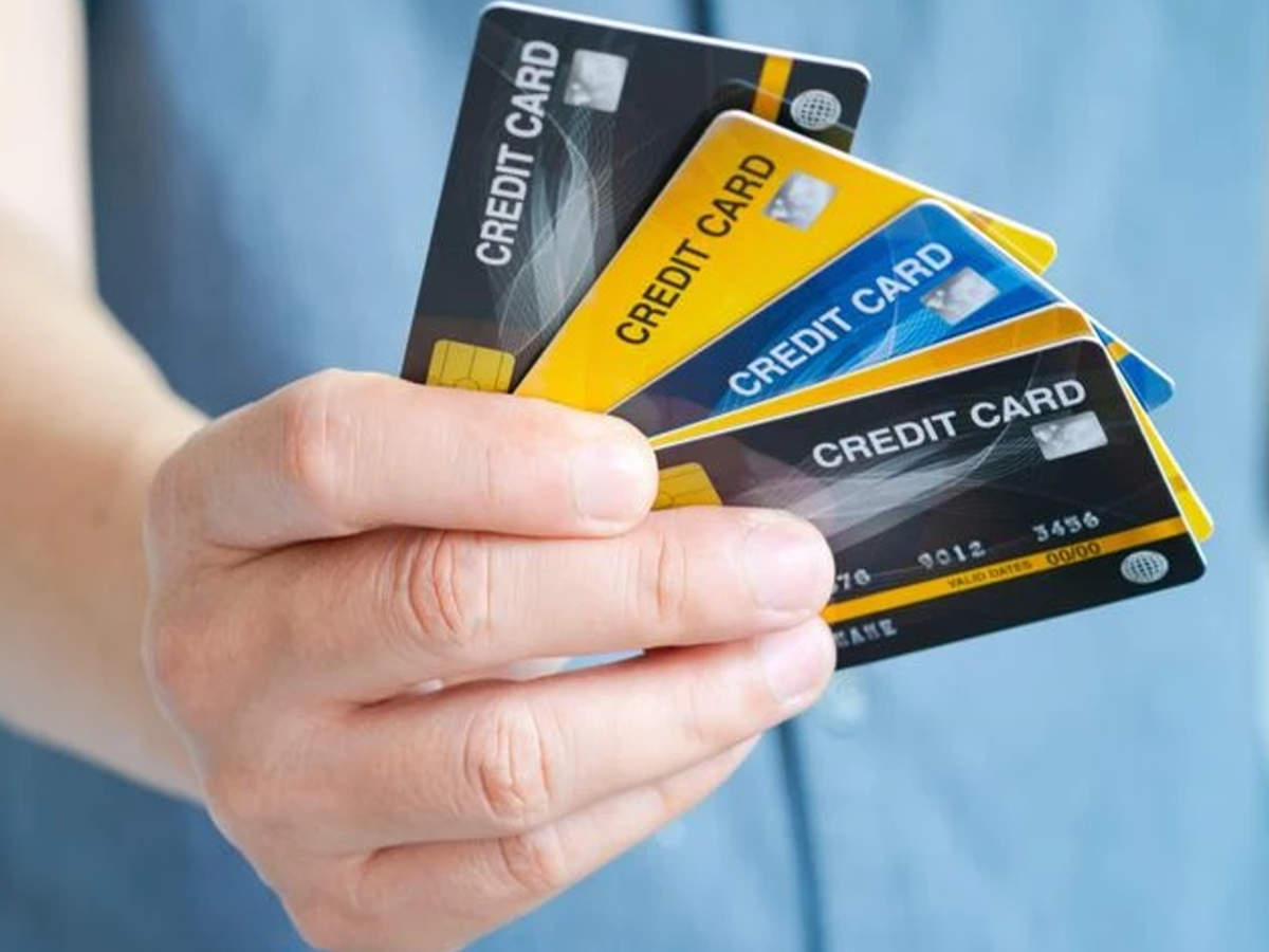 Person reviewing a credit card bill with a calendar, emphasizing timely payments, optimized for SEO.