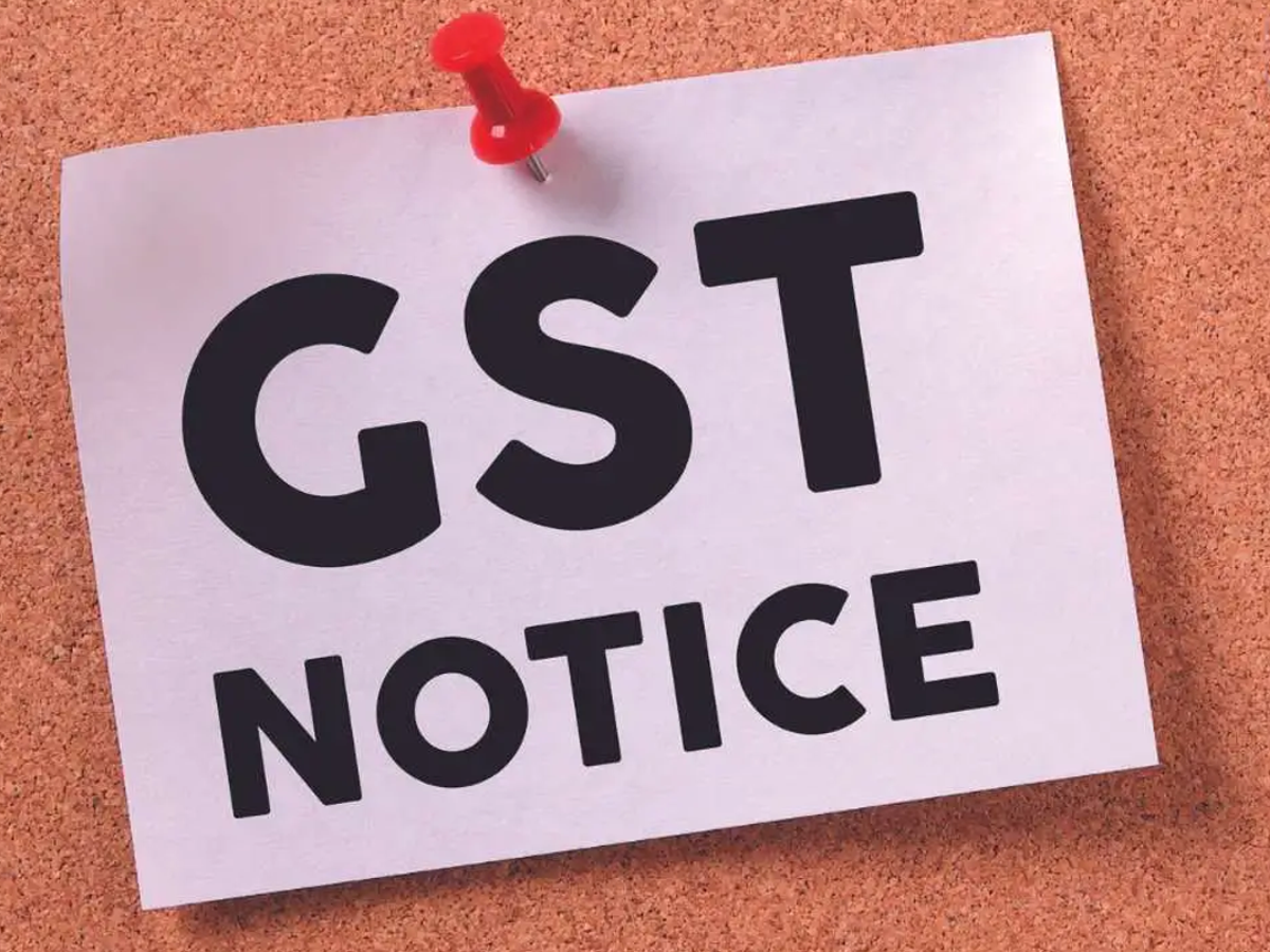 Karnataka tax officials issuing GST compliance notices to traders in a market