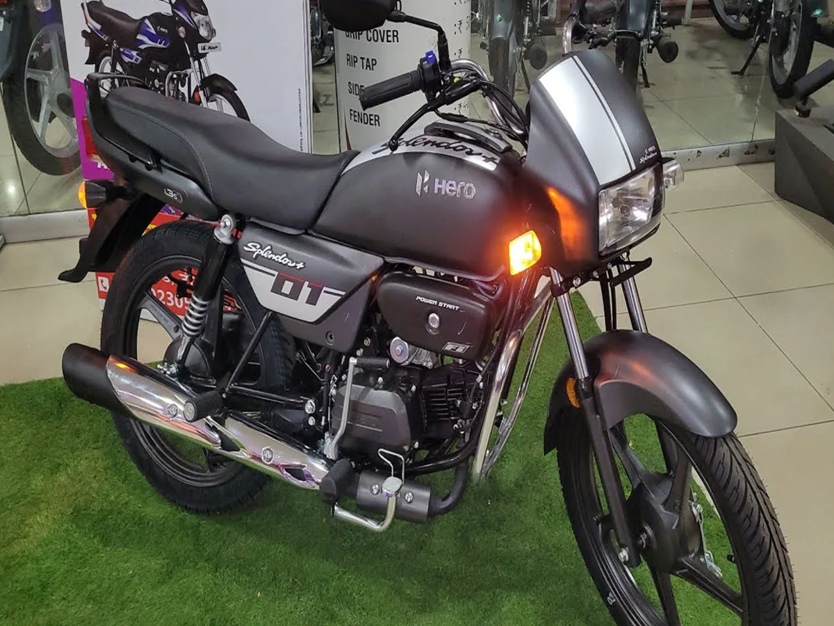 A Bajaj Platina 100 motorcycle parked on a city street, showcasing its sleek design and fuel efficiency.