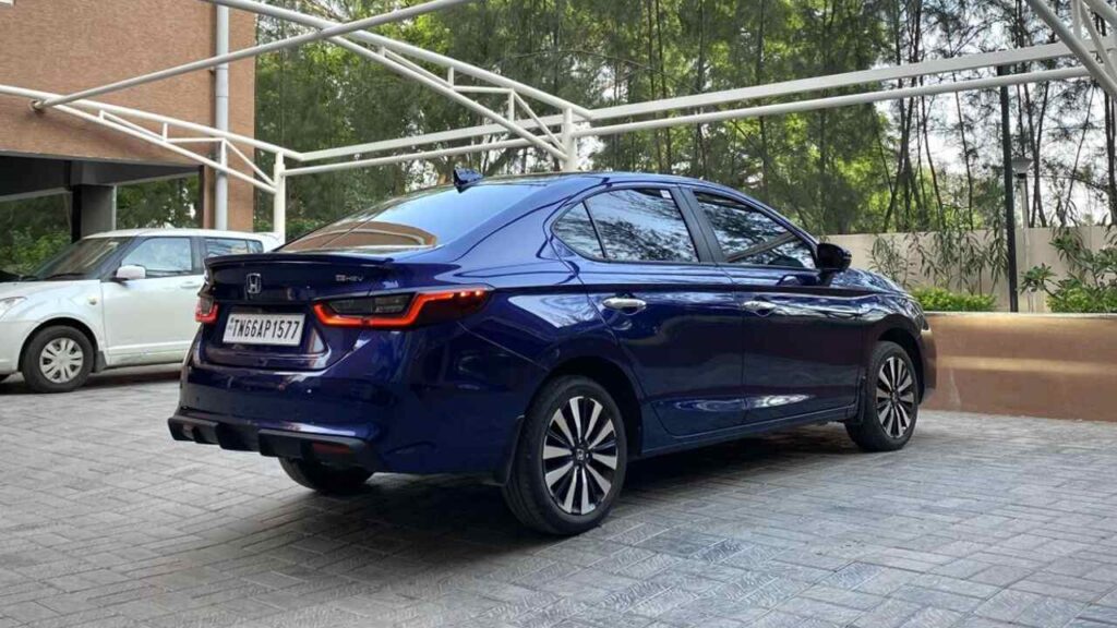 Honda City Hybrid sedan in Platinum White Pearl parked on a Bengaluru street, highlighting its modern design.