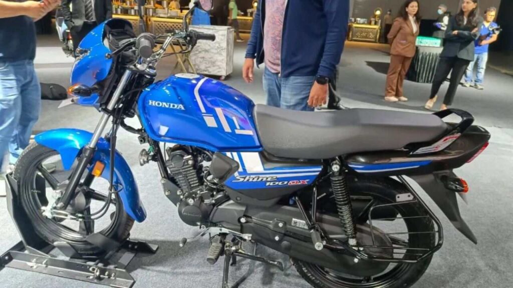 Honda Shine 100 DX motorcycle with chrome headlamp garnish and refreshed graphics