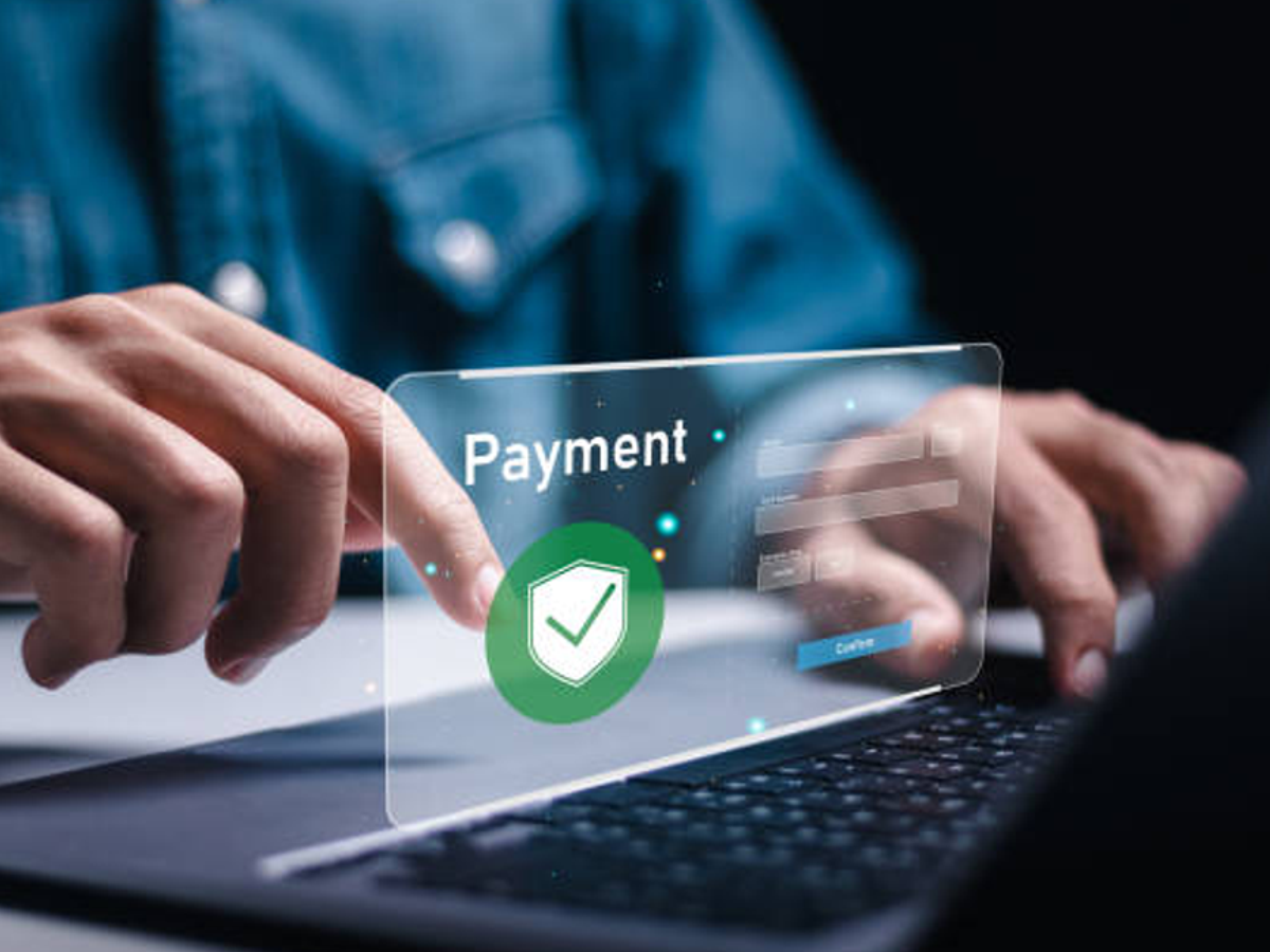 Person smiling while using mobile for fast biometric payment, highlighting security and convenience in e-commerce transactions.