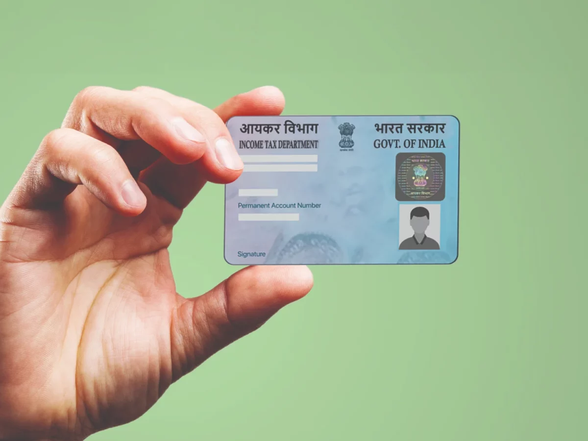 Official PAN card with updated address details displayed alongside Aadhaar card.