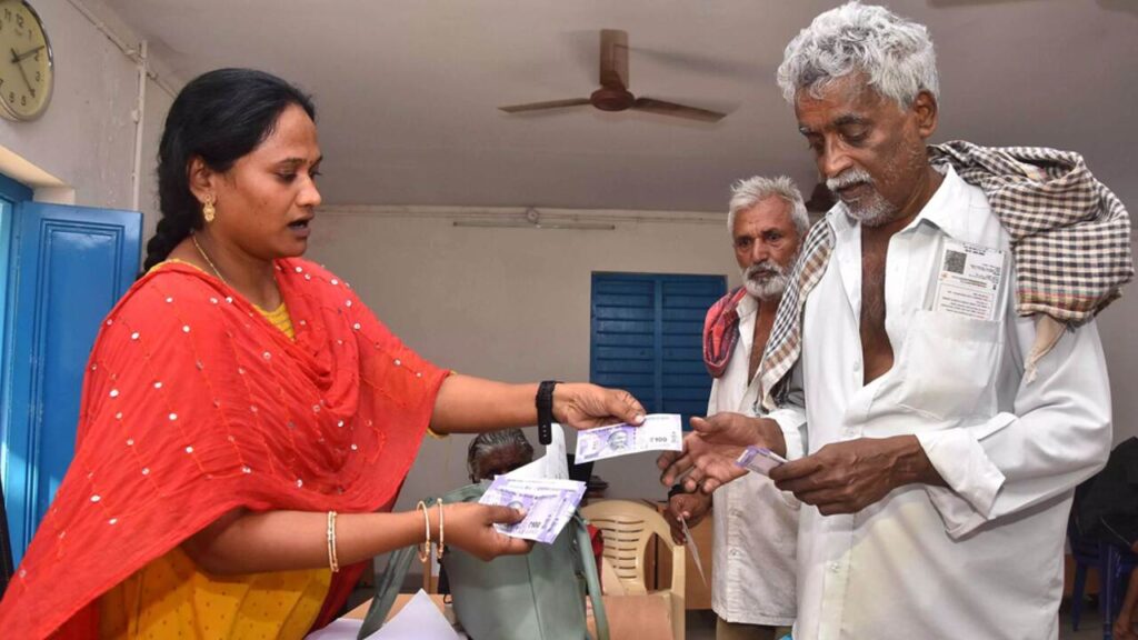 Karnataka government official assisting senior citizens with Sandhya Suraksha scheme
