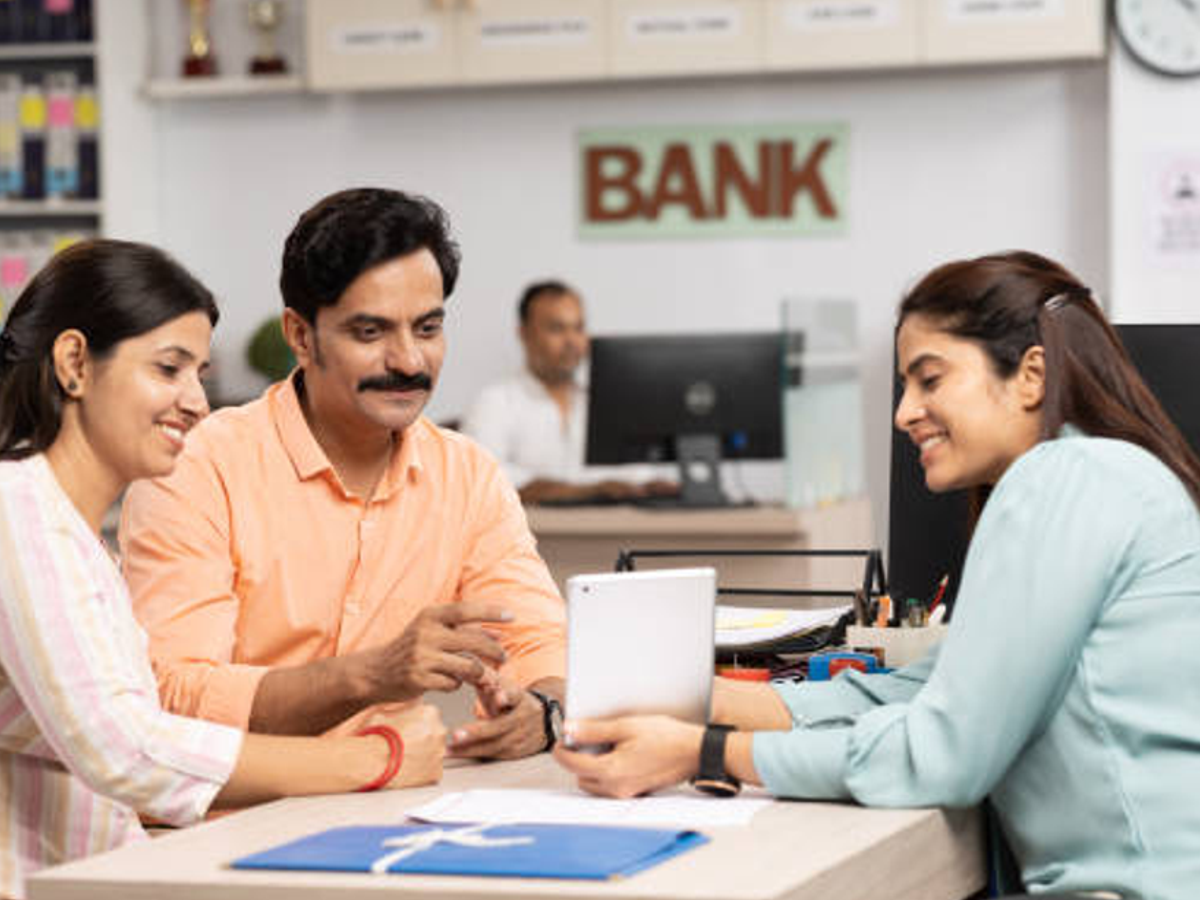 A family in Karnataka discussing financial planning with auto-sweep FD benefits.