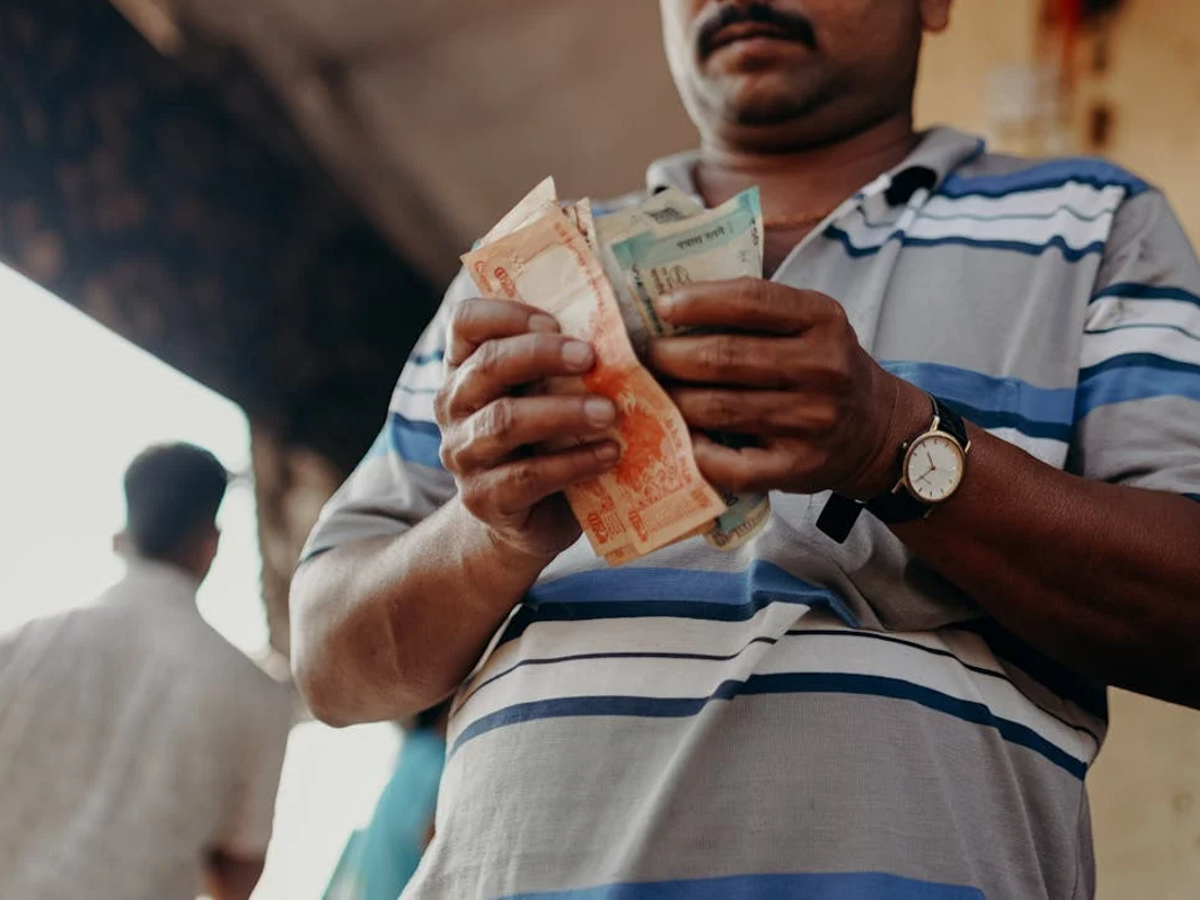A person using a mobile banking app to activate the auto-sweep facility in Karnataka.