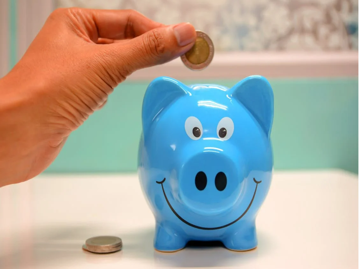 Person planning finances with a calculator and SIP investment documents – A person sitting at a desk with a calculator and financial documents, planning a monthly SIP investment.
