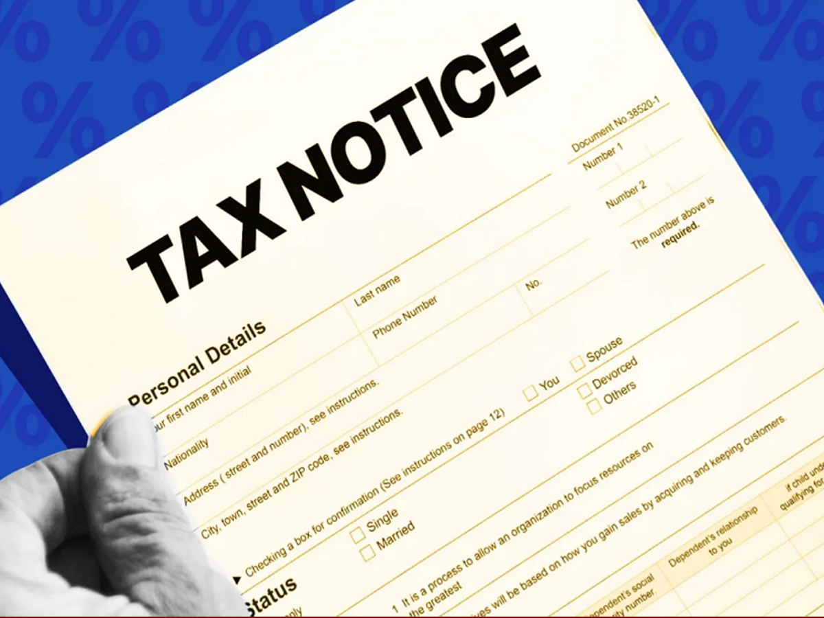 Person depositing cash at a bank counter, illustrating income tax rules for savings account cash deposits.