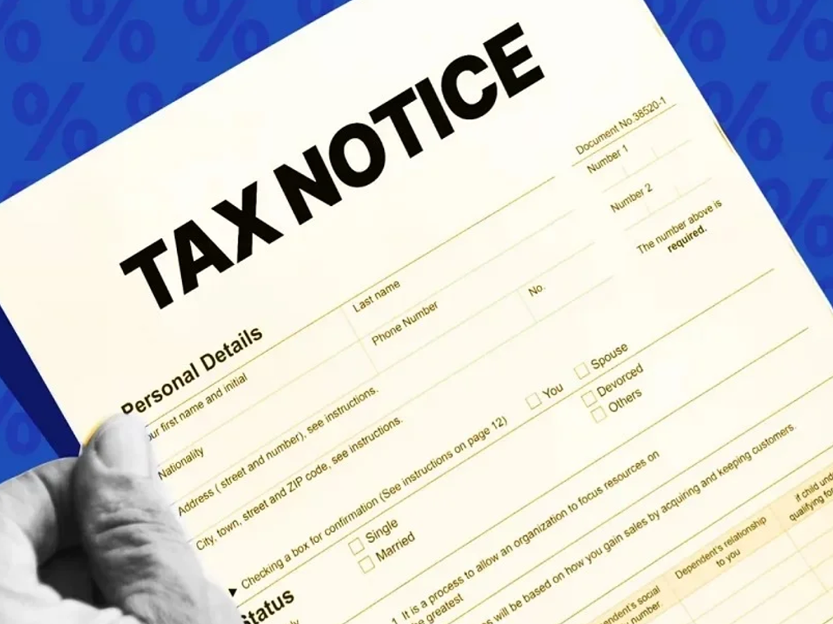 Income Tax Notice document with a magnifying glass for Karnataka