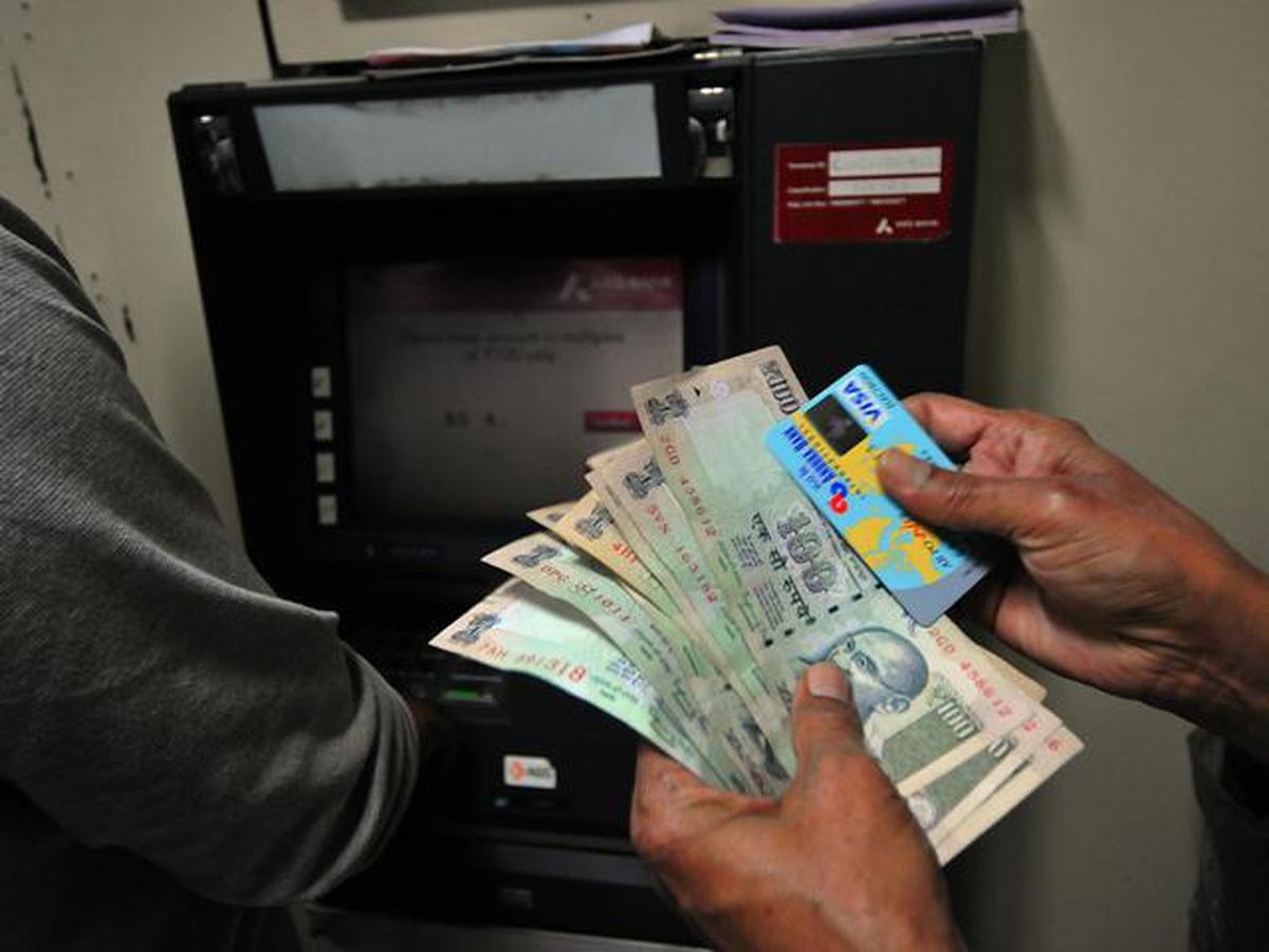 Illustration of an ATM machine with a person withdrawing cash, optimized for SEO.