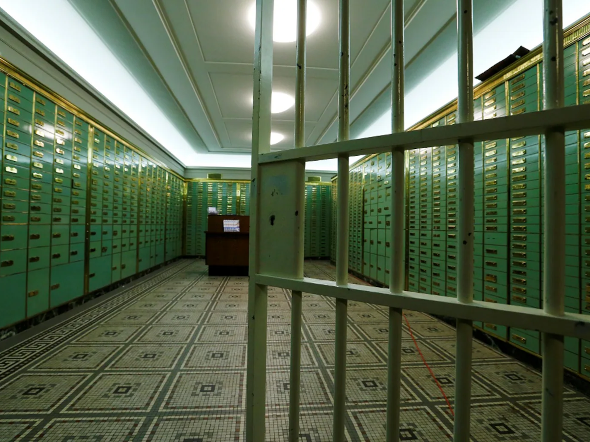 A person checking a bank locker agreement, emphasizing the importance of understanding rules.