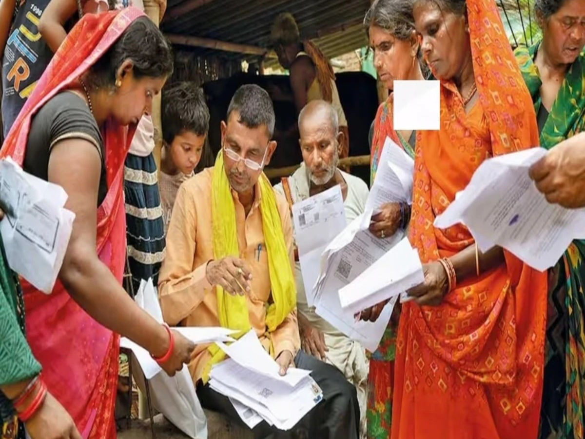 Election Commission of India officials reviewing voter rolls with documents like Aadhaar and ration card in Bihar SIR context.