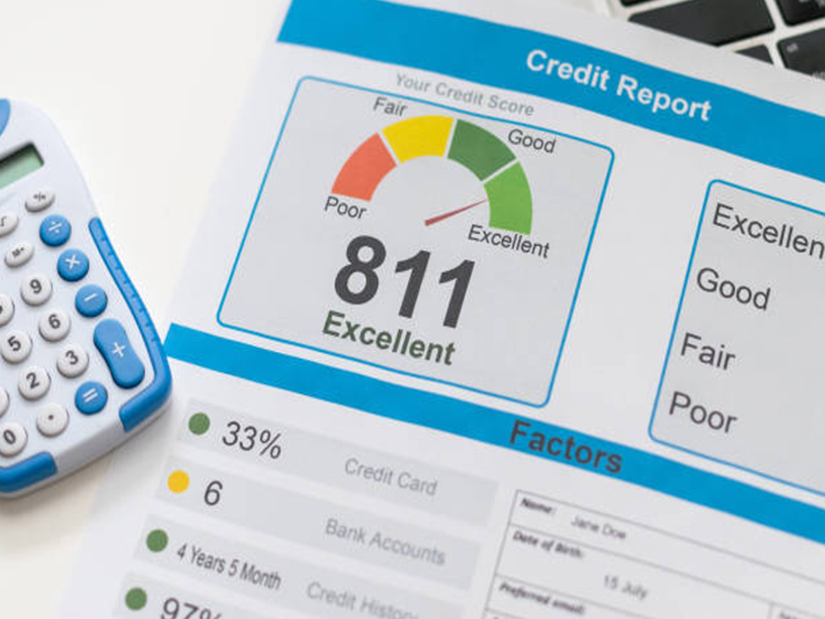 Illustration of a person checking CIBIL score on a laptop with low score reasons