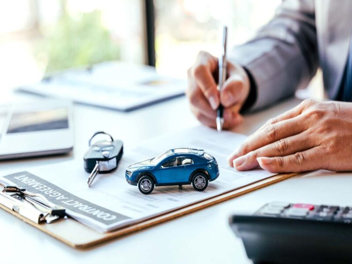 Car owner holding RC document after loan repayment