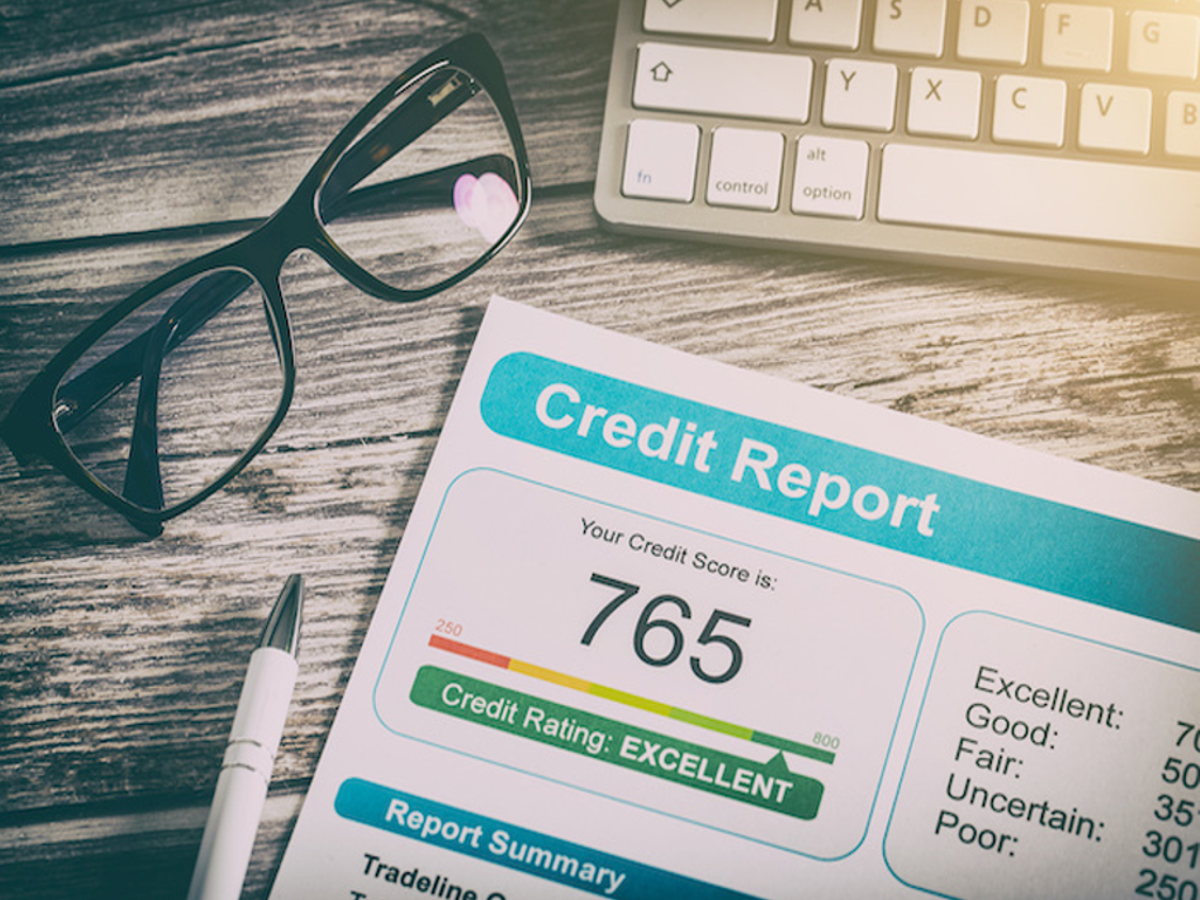 Close-up of a credit report document with a magnifying glass, highlighting the importance of checking for errors.