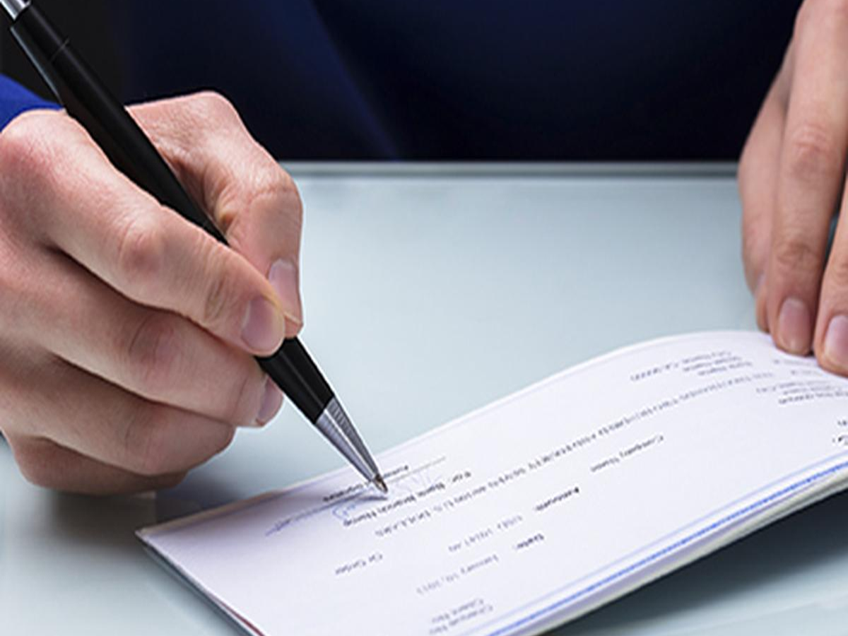 Happy customer receiving fast cheque clearance confirmation at a bank counter.