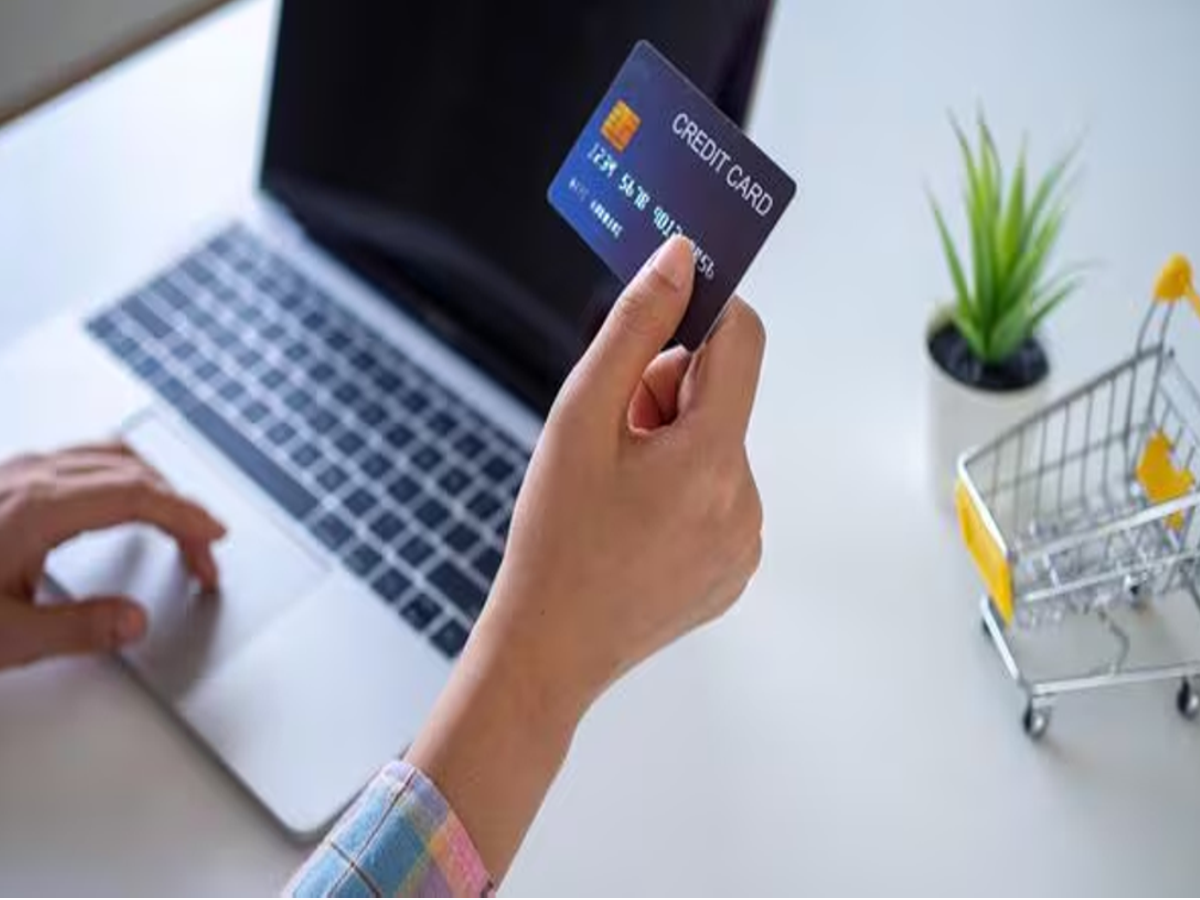 Person reviewing a credit card statement on a laptop, ensuring accurate transactions, optimized for accessibility.