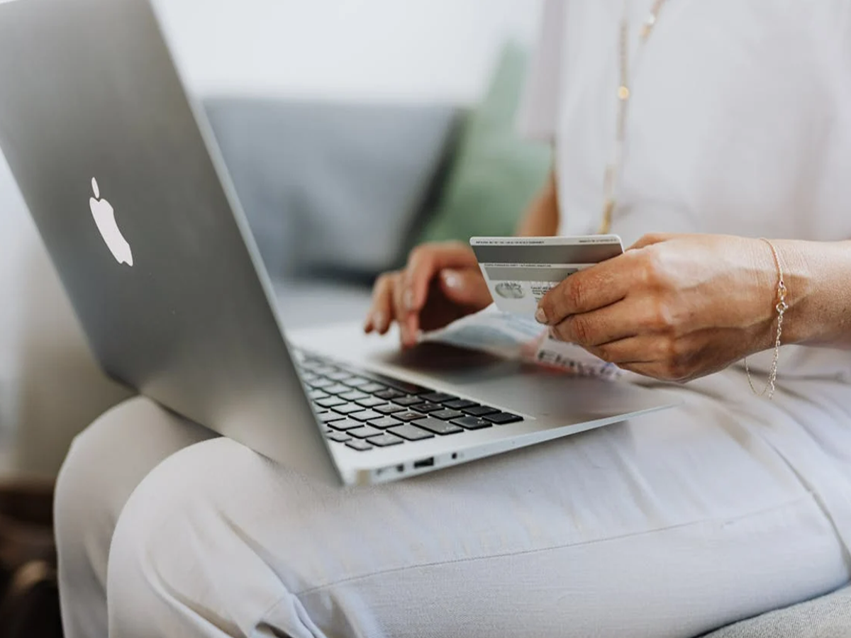 A person reviewing a credit card statement, emphasizing financial awareness.