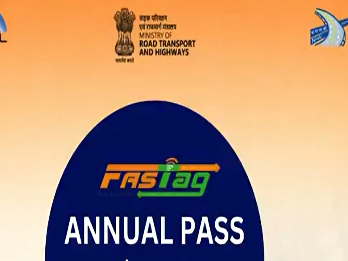 A close-up of a FASTag annual pass sticker on a vehicle windshield.