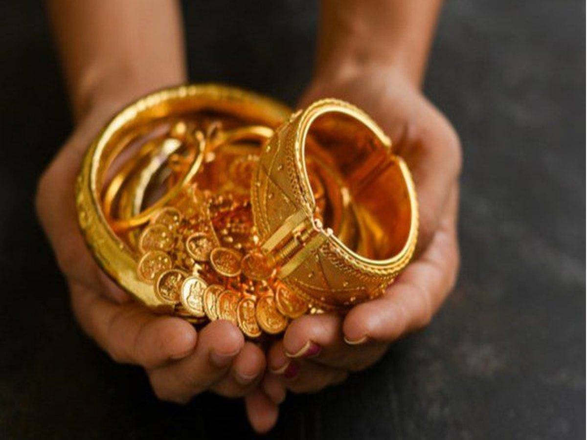 Indian woman wearing gold ornaments, illustrating cultural significance of gold.