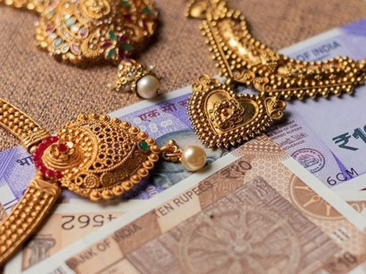Gold jewellery displayed on a table, representing legal gold storage limits in India.