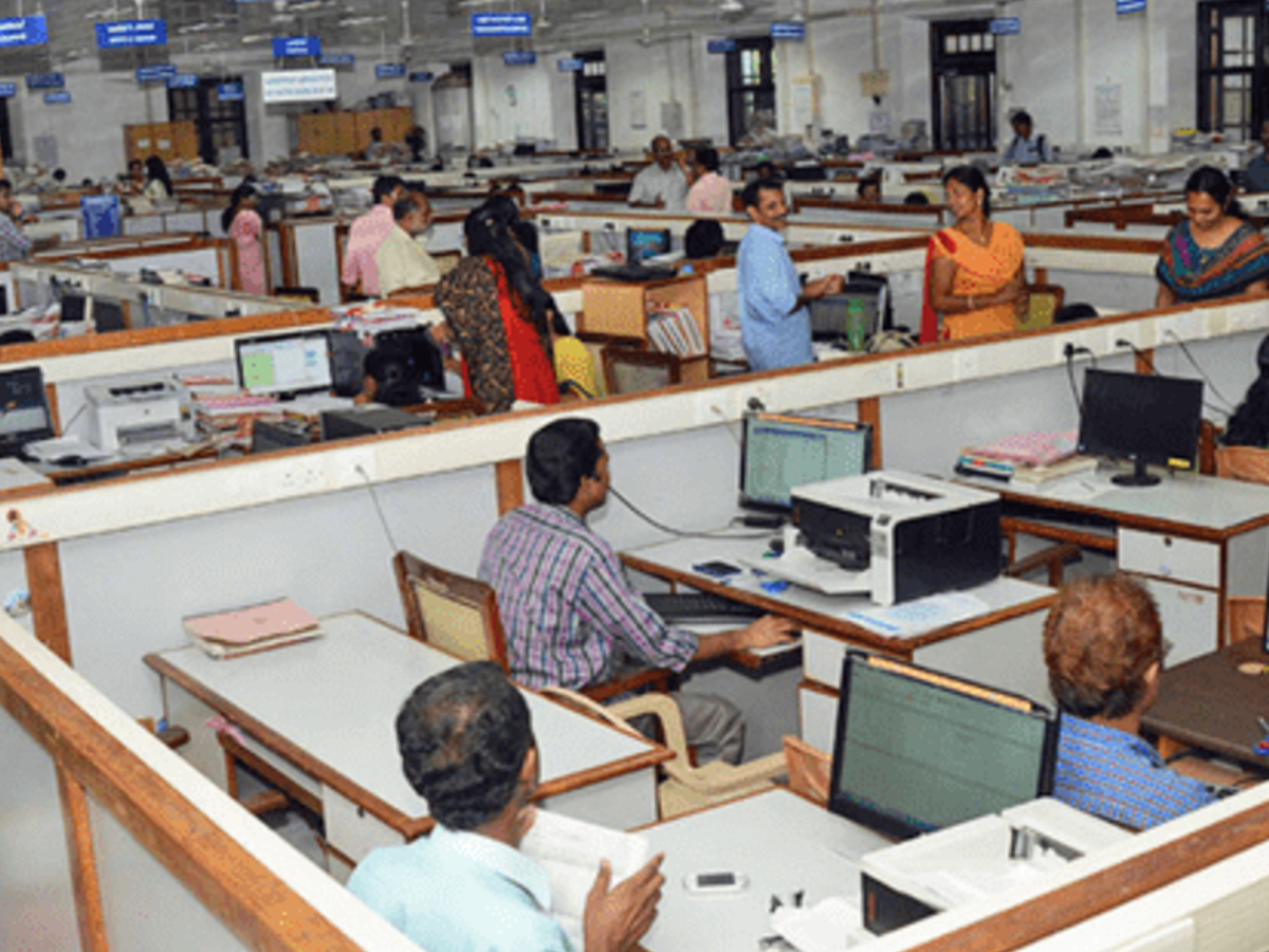 Central government employees reviewing leave policy documents in a modern office environment