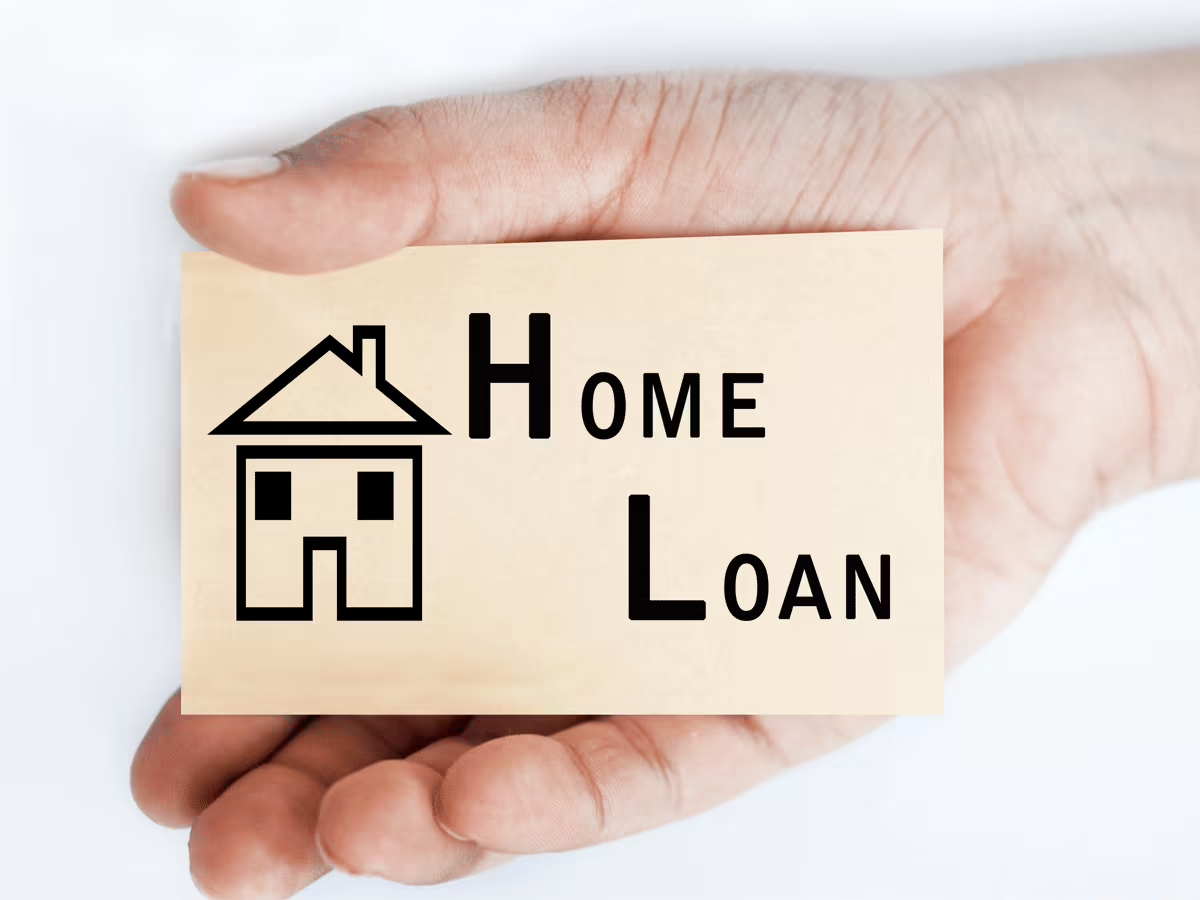 Family discussing home loan insurance options – A family at a table with financial documents, discussing home loan insurance benefits in a cozy home setting.