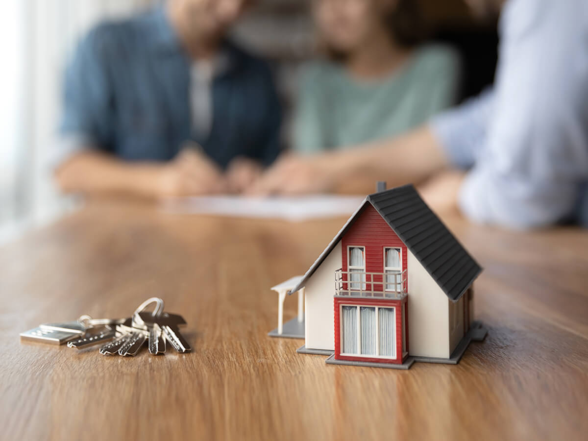 Person reviewing home loan insurance policy – A person reading a home loan insurance policy document with a bank logo in the background.