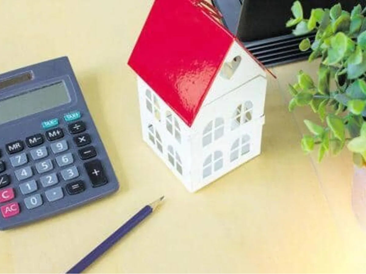 Person filling out an ITR form on a laptop, symbolizing tax compliance for house property income.
