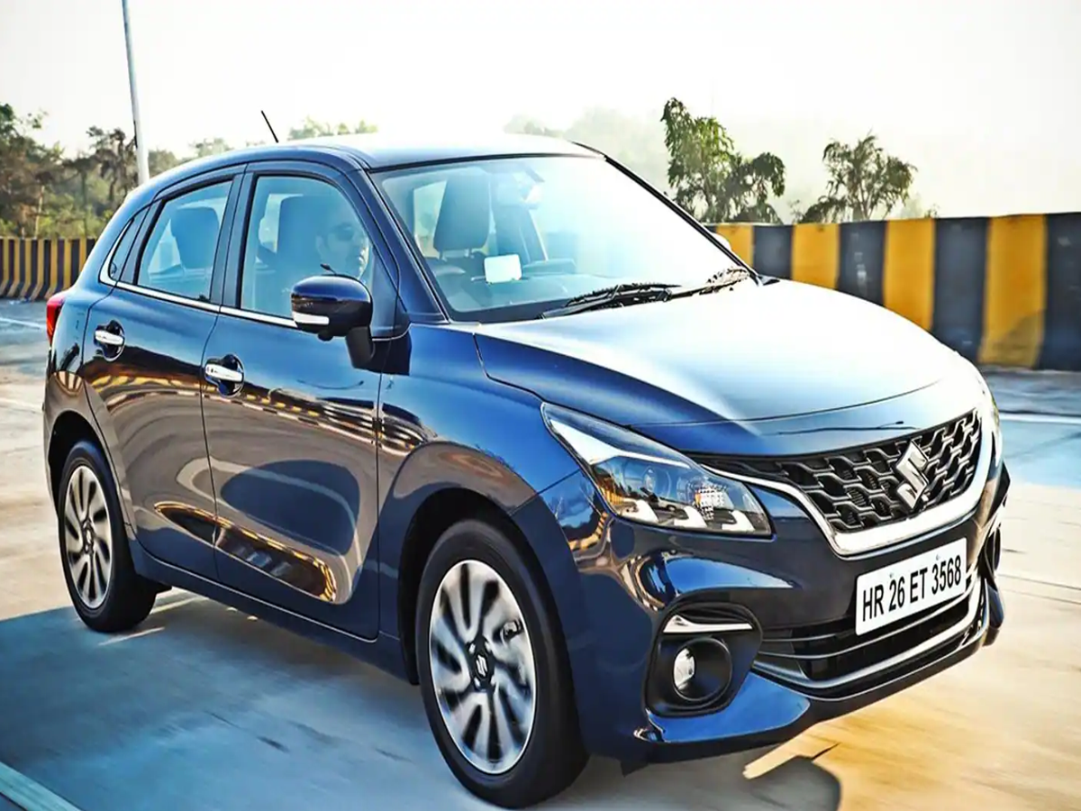 Maruti Suzuki Baleno AMT parked in a city street, showcasing its sleek design.