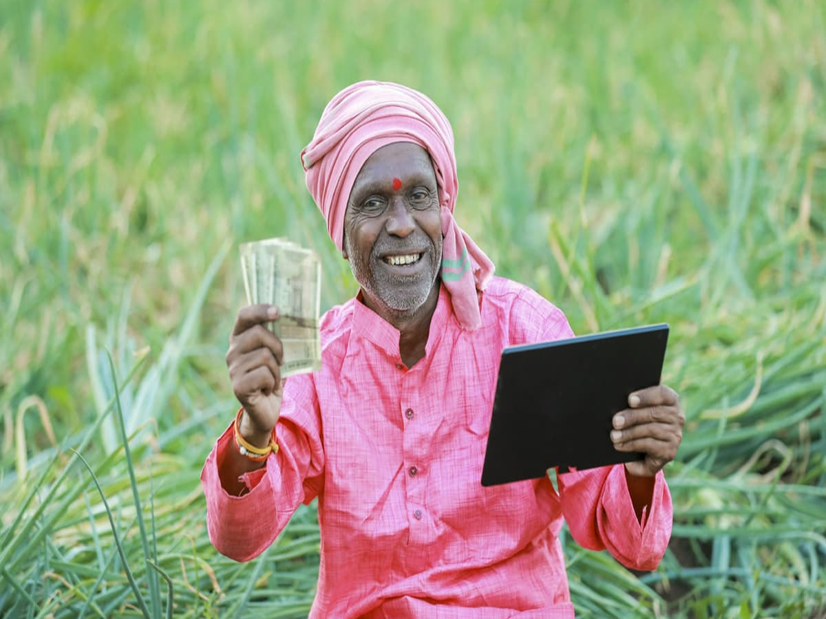 Farmer checking PM Kisan beneficiary status on a smartphone.