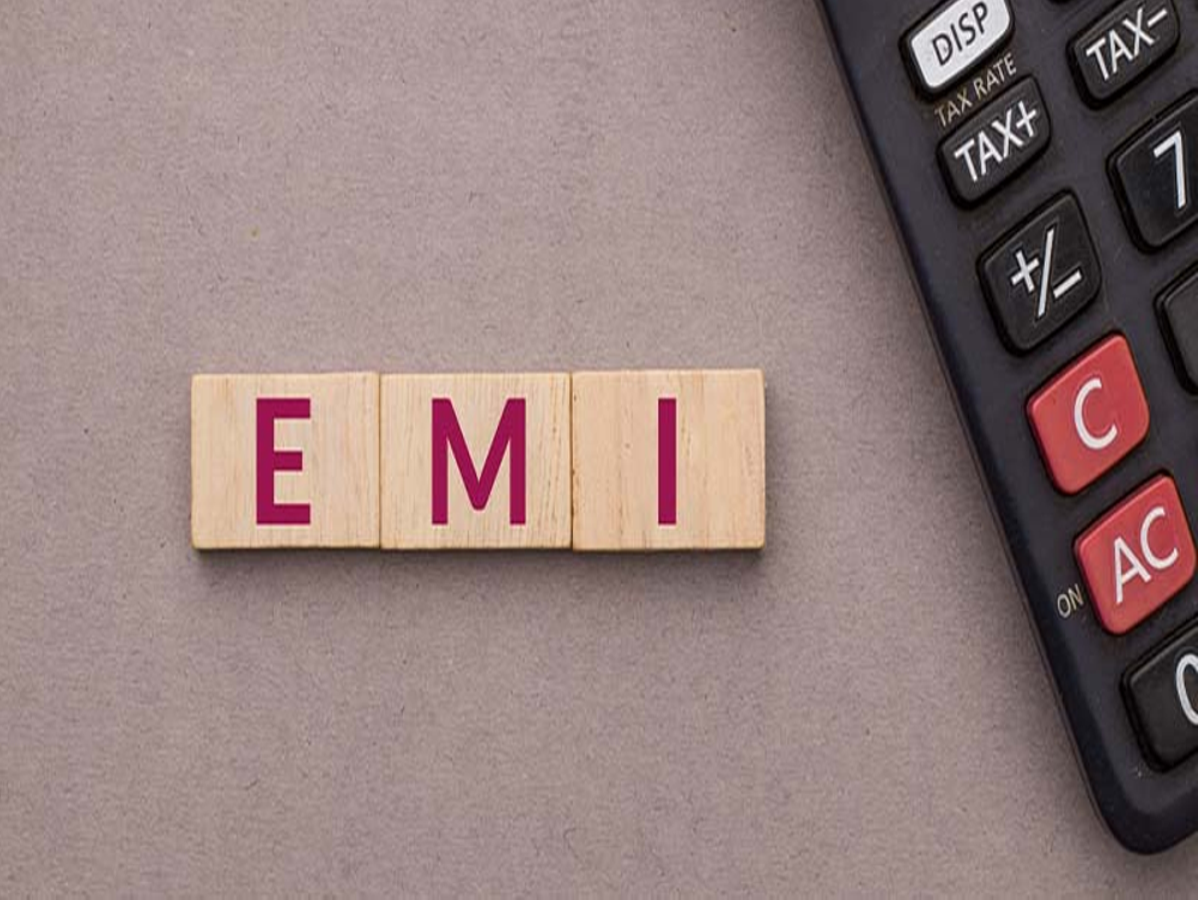 Person discussing loan issues with a bank representative, illustrating communication for missed EMI solutions.