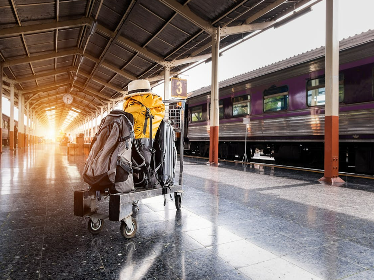 Indian Railways train at a station with passengers and luggage, showcasing new luggage rules.