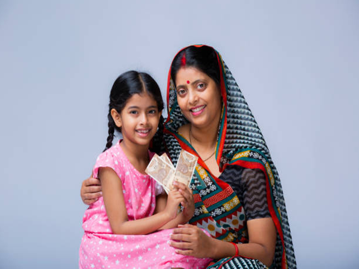 A happy Indian family discussing Sukanya Samriddhi Yojana savings plan at a post office.