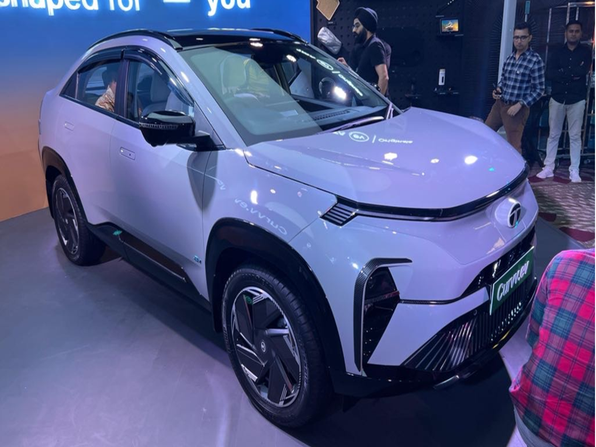 Tata Curvv EV coupe style electric SUV in motion on Indian roads.