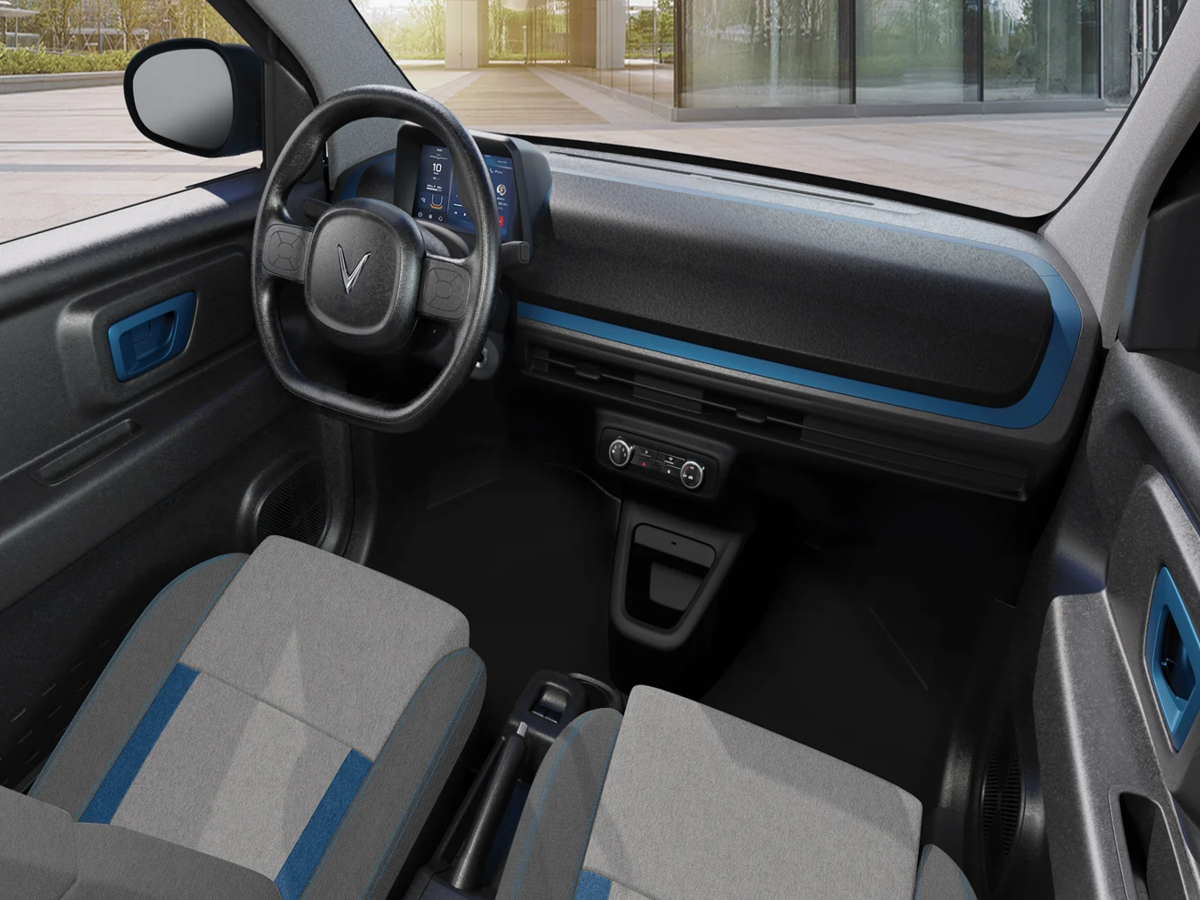 Interior view of VinFast Minio Green EV with a minimalist dashboard and digital driver’s display.