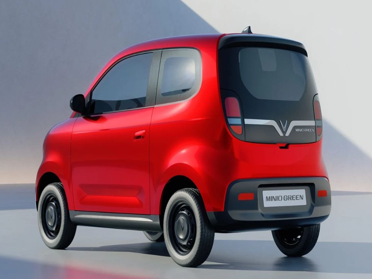 VinFast Minio Green EV parked on a city street, showcasing its compact design and LED headlights.