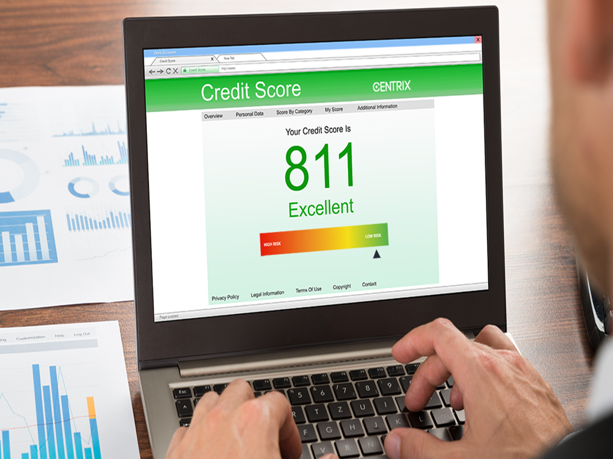 A confident individual holding a credit card and a financial report, symbolizing financial preparedness.
